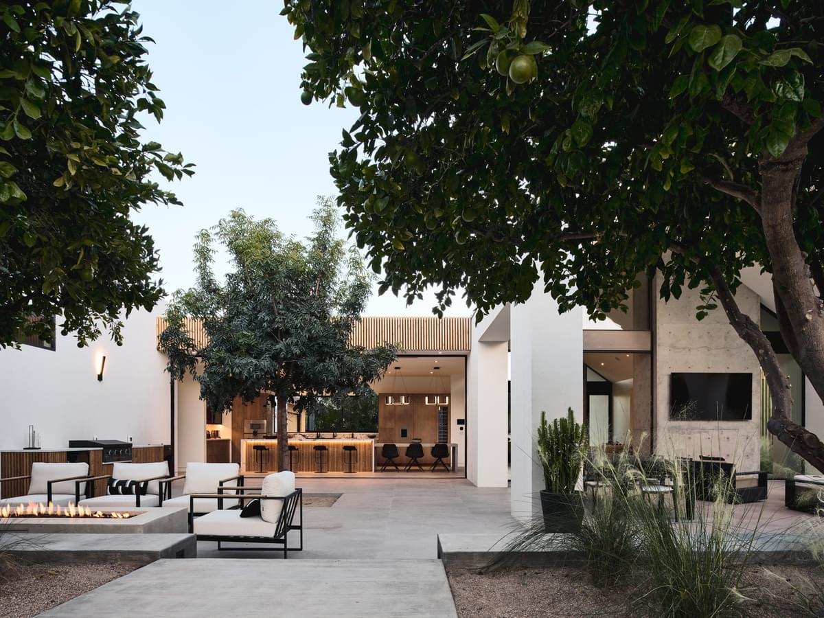 Original listing photo: courtyard with fire pit at dusk