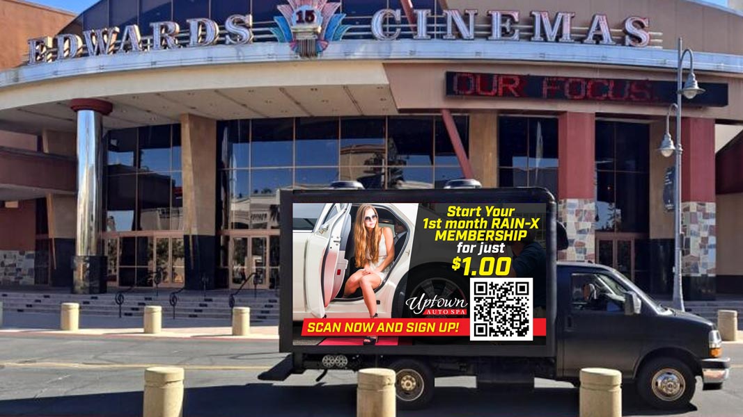 led truck billboard parked outside movie theater